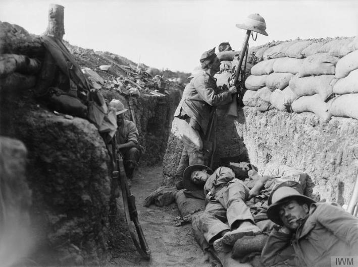 A Royal Irish Fusilier attempts to draw the fire of a Turkish sniper to reveal the enemy position, Gallipoli, 1915 © IWM (Q 13447)